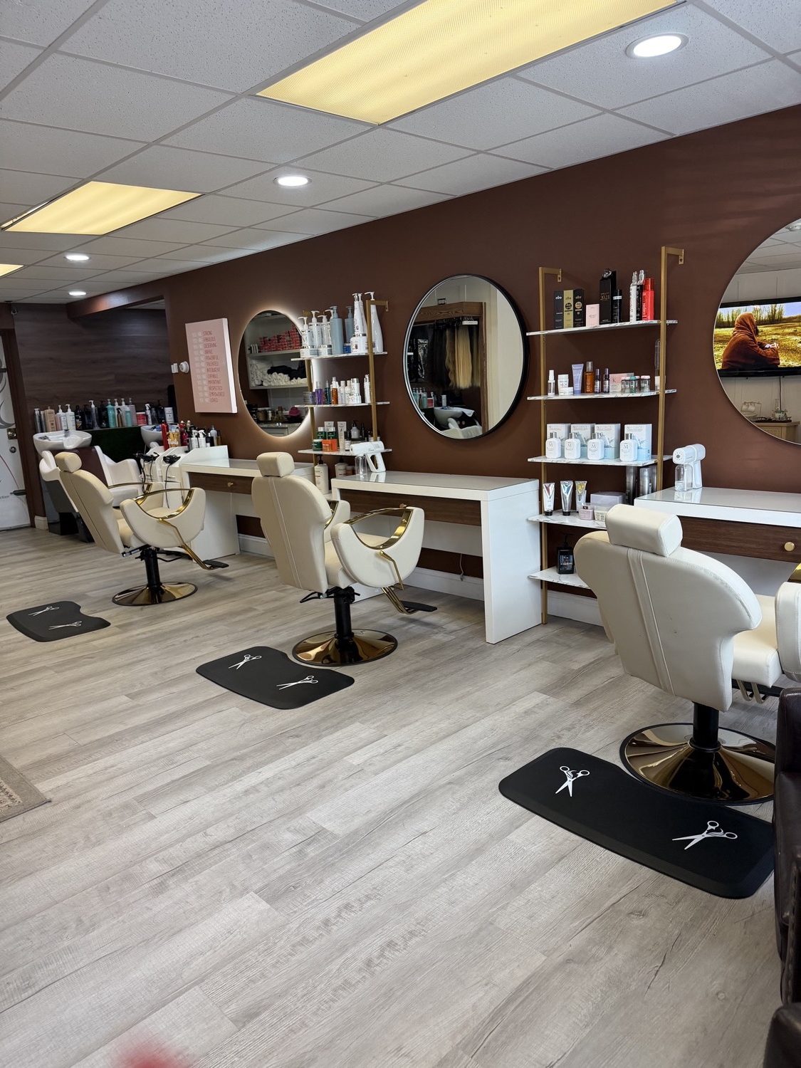 Beauty Space salon interior — styling stations with gold accents and round LED mirrors